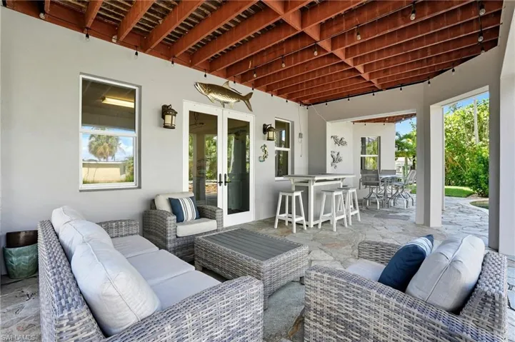 View of patio / terrace with outdoor lounge area, outdoor dining area, and french doors - Virtually Edited Image