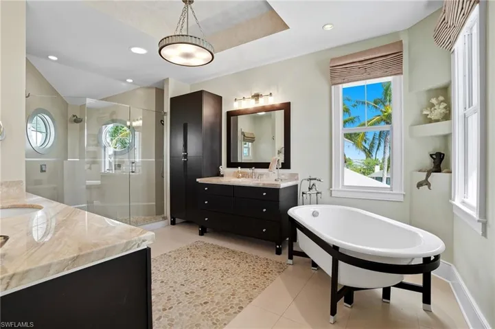 Bathroom with a shower stall, two vanities, plenty of natural light, a soaking tub, and recessed lighting - Virtually Edited Image