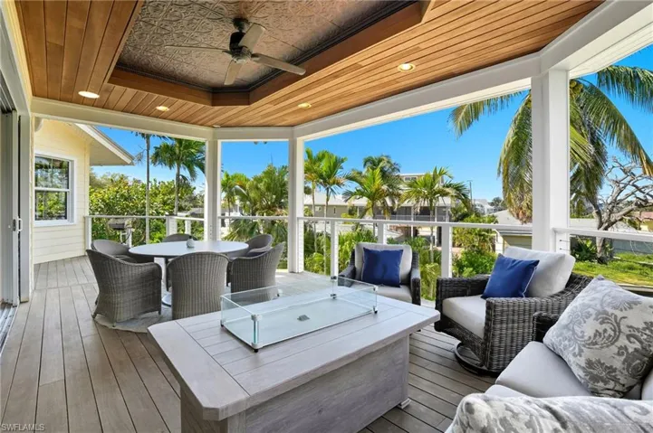 Deck with outdoor dining area, a ceiling fan, and an outdoor living space - Virtually Edited Image