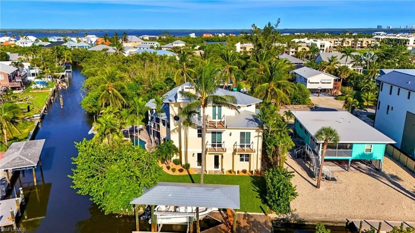 Balcony featuring boat lift and a water view - Virtually Edited Image