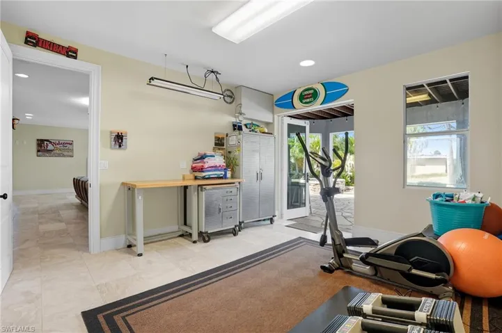 Exercise area featuring baseboards and recessed lighting - Virtually Edited Image