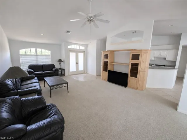Living Room with AI Editing - Doors to Lanai and Pool!