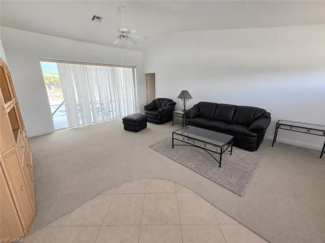 Living Room with AI Editing - Doors to Lanai and Pool!