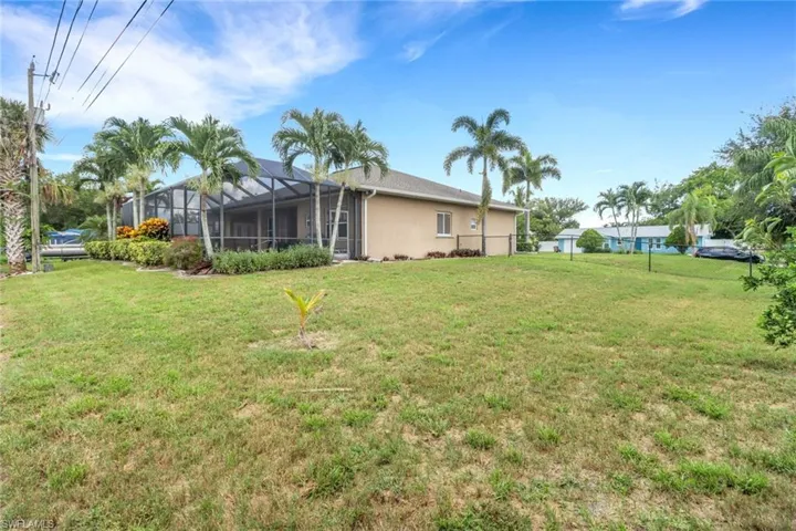 View of green lawn featuring a lanai