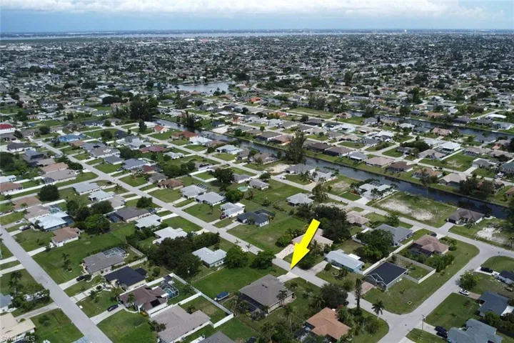 Aerial overview of property's location with nearby suburban area and a large body of water