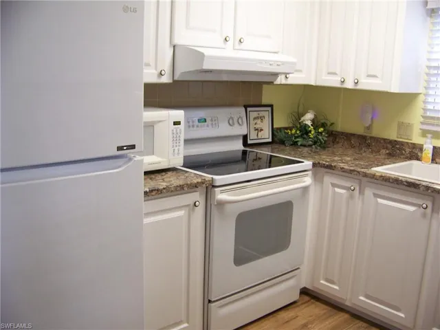 One of 3 pics, newer countertops, cabinet doors, sink and faucet.