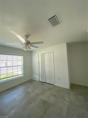 Unfurnished bedroom with a closet and ceiling fan
