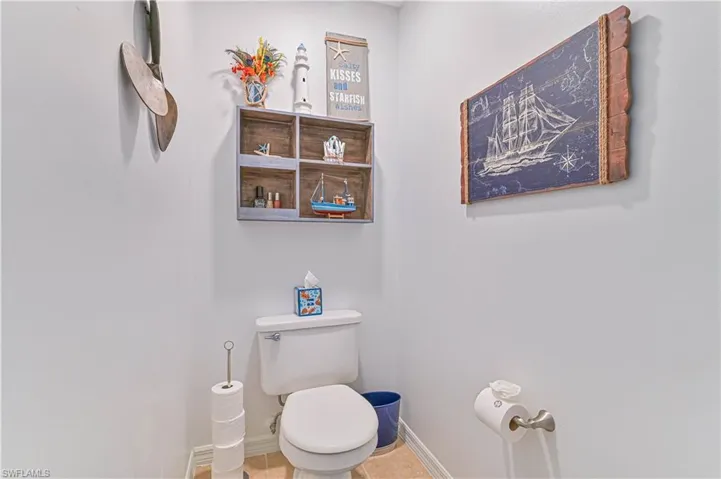 Bathroom with toilet and baseboards