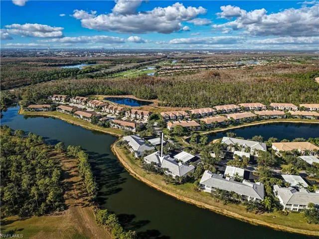 Aerial perspective of suburban area featuring a nearby body of water
