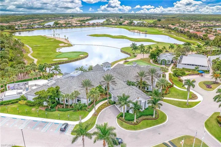 Aerial perspective of suburban area with a large body of water and a golf course