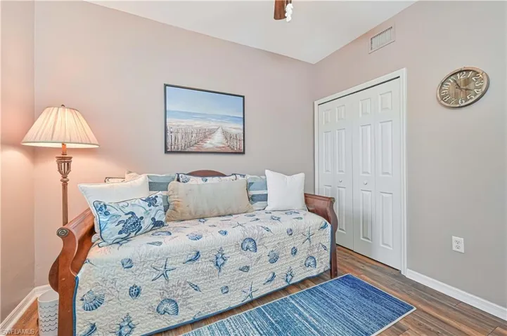 Bedroom featuring wood finished floors, a closet, and ceiling fan
