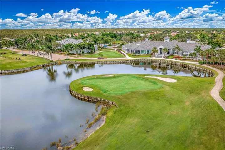 Drone / aerial view of a local golf course and a nearby body of water