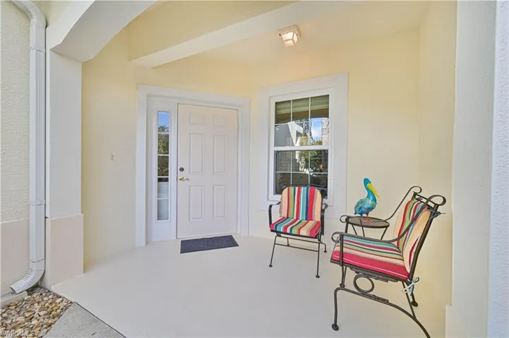 Property entrance with stucco siding and a patio
