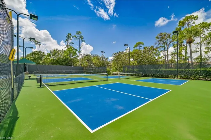 View of tennis court with community basketball court