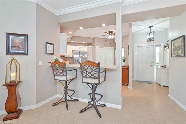 Foyer entrance featuring recessed lighting, ceiling fan, light tile patterned floors, and crown molding
