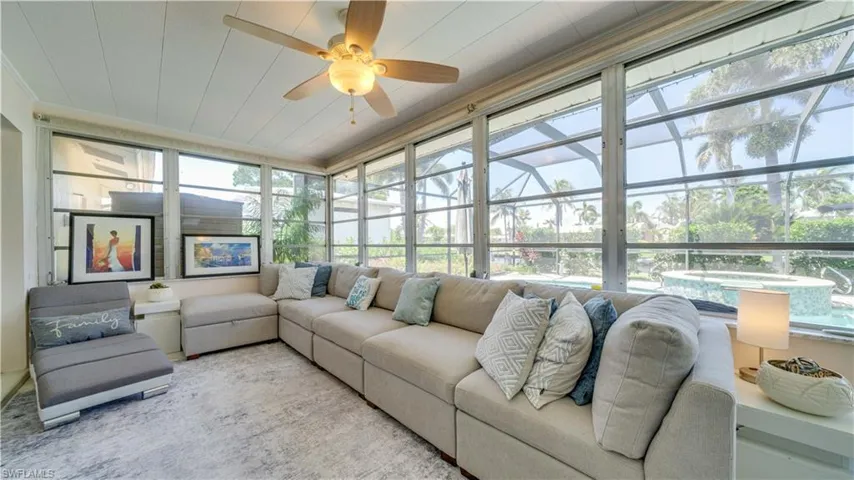 Sunroom / solarium featuring a beautiful view of the pool and canal.
