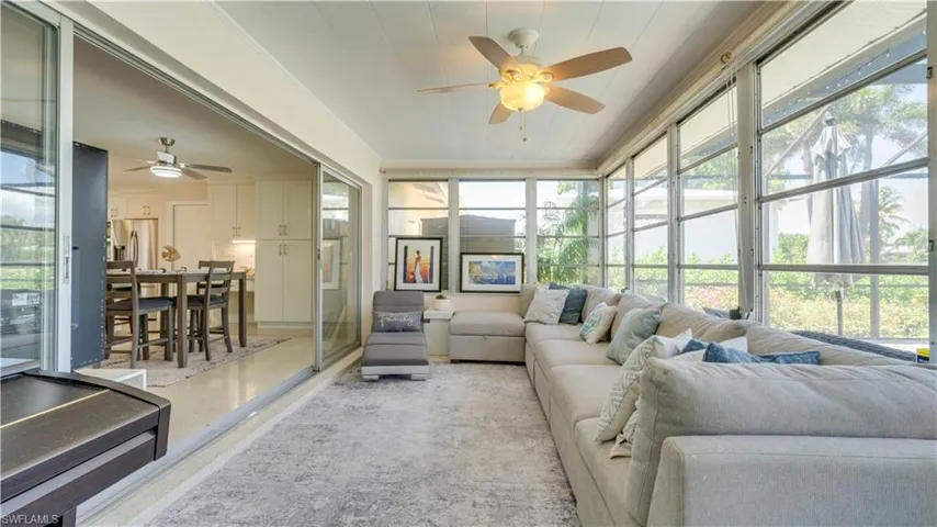 Sunroom / solarium with an outdoor living space, a ceiling fan, and plenty of natural light