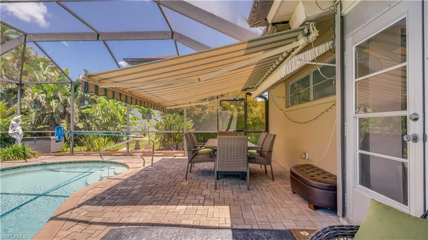 View of patio with the electric retractable awning in use!