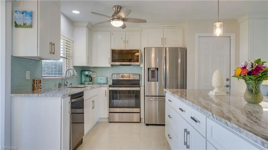 Custom upgraded kitchen with granite counters, stainless appliances, and beautiful cabinetry.