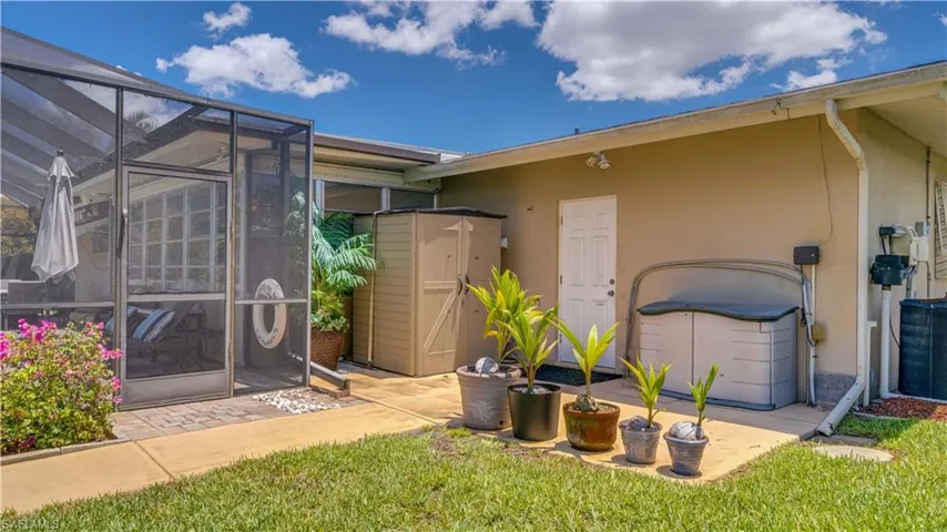 Back of garage has extra storage and an open patio area for gardening, barbeque, etc.