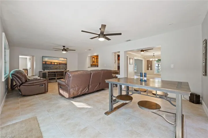 Living room featuring a ceiling fan and light tile patterned flooring