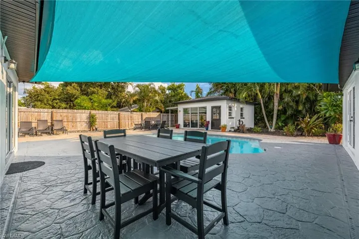 View of patio featuring an outdoor structure, outdoor dining space, and an exterior structure