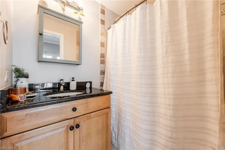 Full bath with vanity and a shower with curtain