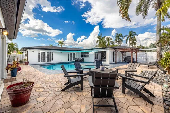 View of pool featuring a patio area, a pergola, french doors, and grilling area