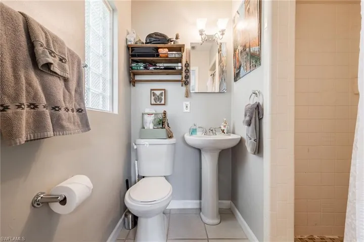 Full bath featuring tile patterned flooring and a stall shower