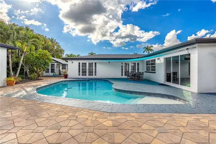 Swimming pool featuring french doors and a patio