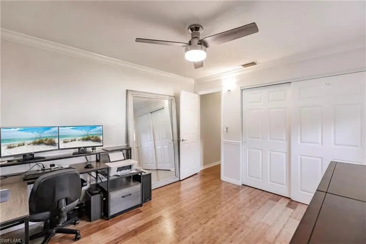 Office featuring ornamental molding, light hardwood / wood-style flooring, and ceiling fan