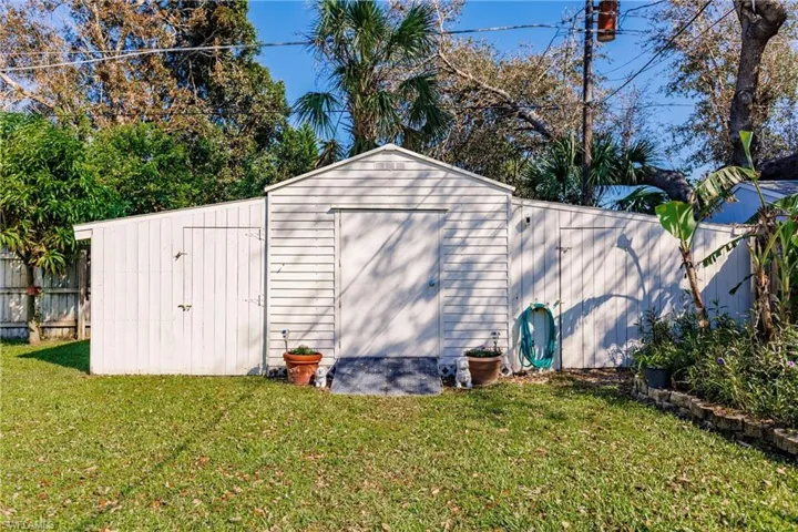 View of outdoor structure with a lawn