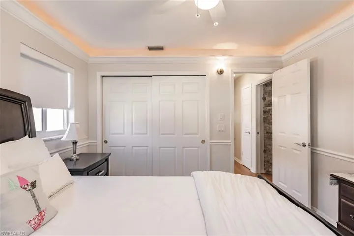 Bedroom with ceiling fan, a closet, and crown molding
