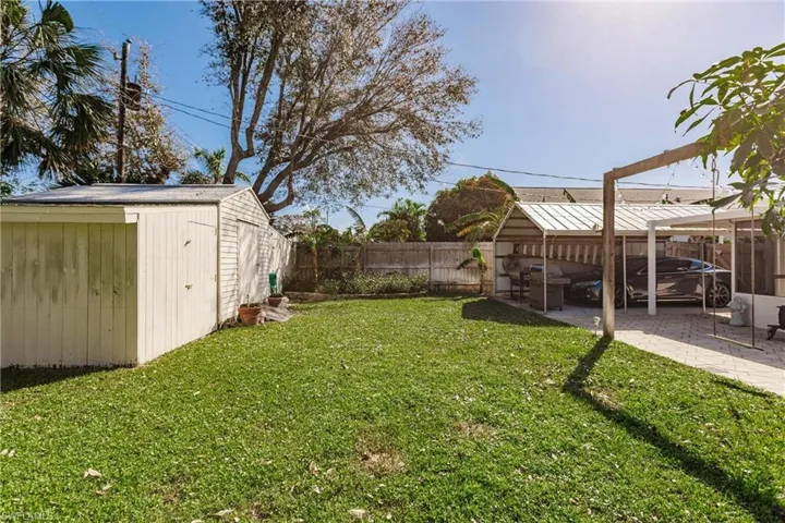View of yard featuring a storage shed and a patio area