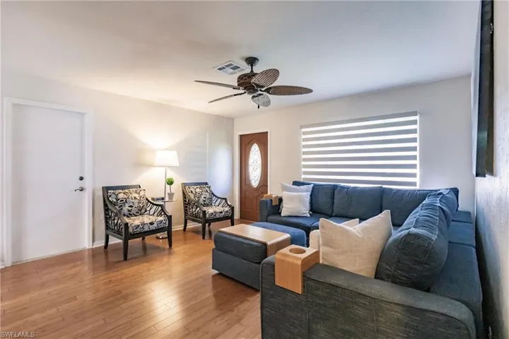 Living room with wood-type flooring and ceiling fan