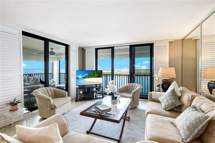 Tiled living area featuring a wall of windows