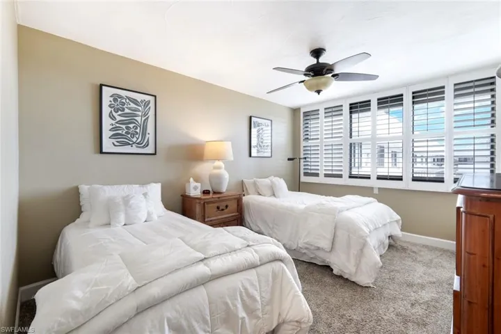 Bedroom with carpet and a ceiling fan