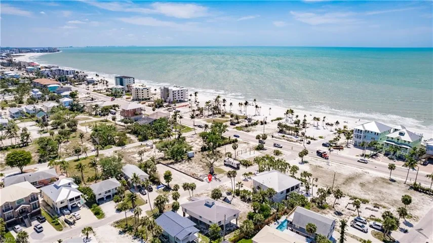 Drone / aerial view with a water view and a beach view