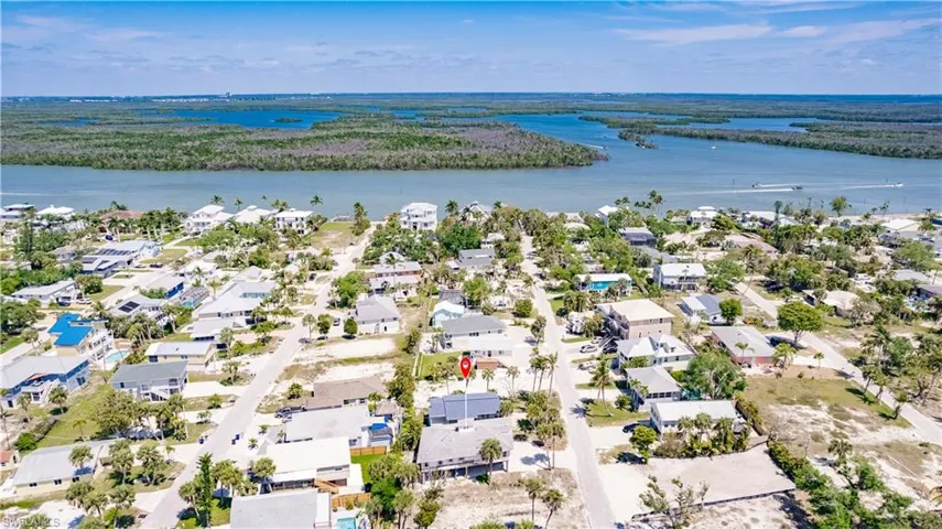 Birds eye view of property with a water view