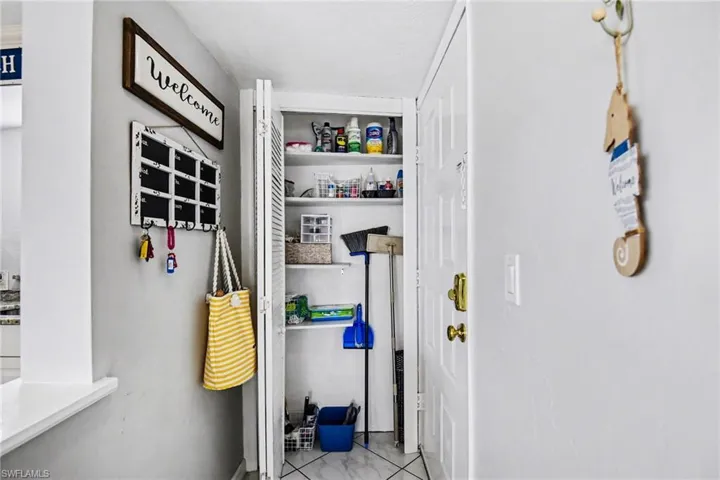 CONVENIENT LITTLE PANTRY AREA BETWEEN UNIT ENTRANCE AND KITCHEN
