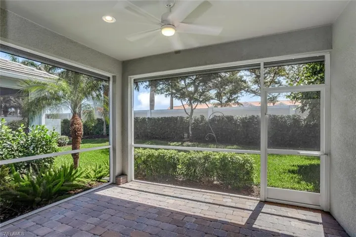 Breezy private screened lanai with landscaped views. Right off of the great room and primary suite.