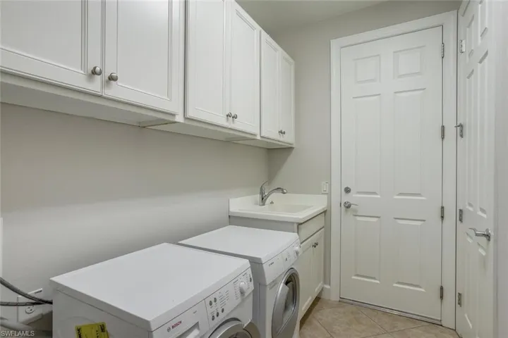 Large separate laundry room with washer and dryer included plus laundry tub. Extra cabinets always a plus!
