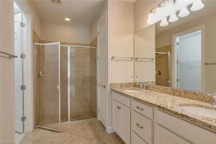 Primary ensuite with dual vanity, large walk in shower, linen closet.