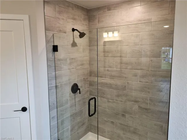 Full bath featuring a shower stall