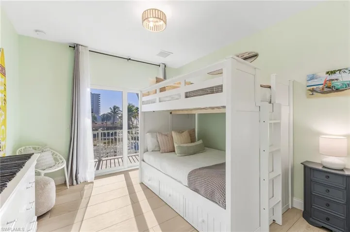 Bedroom featuring light tile patterned floors and baseboards