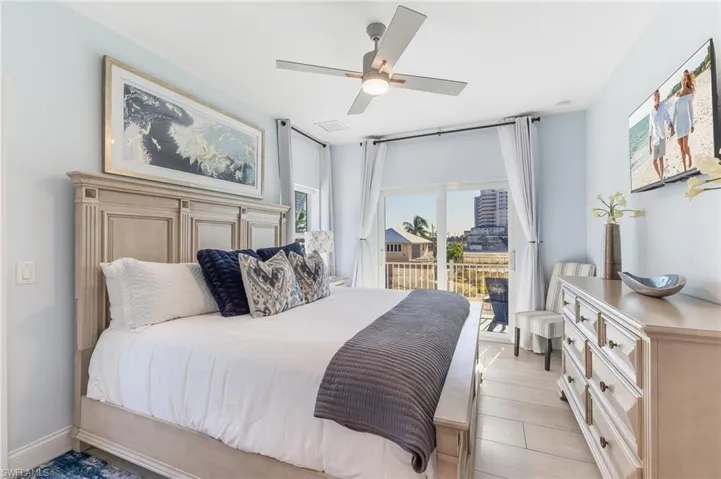 Bedroom featuring ceiling fan, access to outside, and light wood finished floors