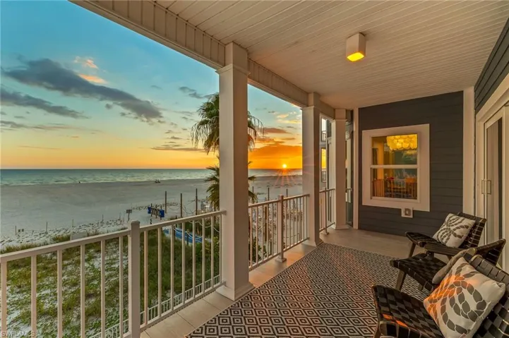 Balcony with view of water and beach