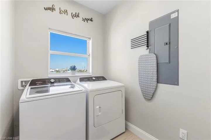 Washroom with electric panel and washer and dryer