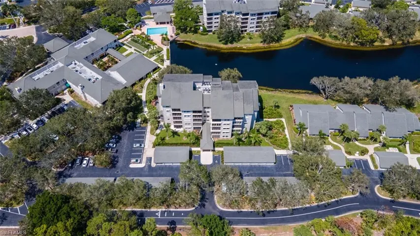 View of property location featuring apartment complex / building and a nearby body of water