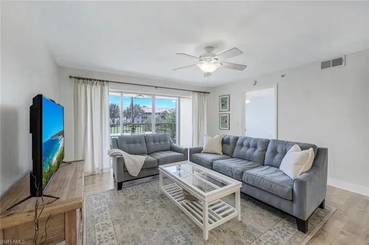 Spacious living room with golf course view.